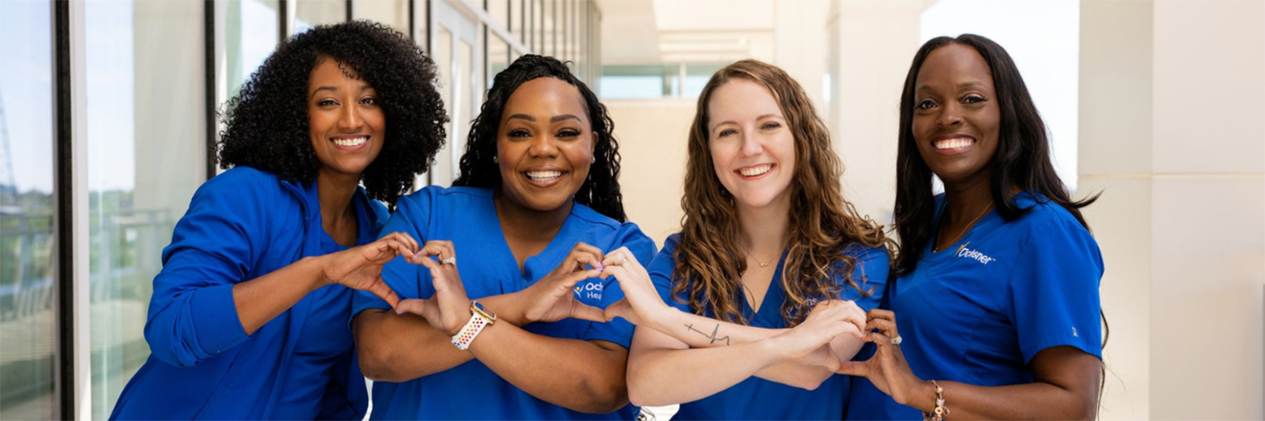 Landing Page Hero Banner: Four women in scrubs making a heart with their hands while smiling at the camera